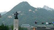 Statue of Admiral Yi Sun-sin and the mountain. The Blue House and the Statue of King Sejong can also be seen in the bottom. (2011)