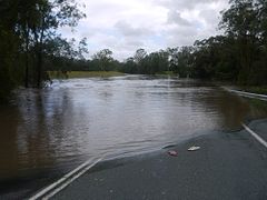 Water over the Beaudesert-Beenleigh Road at Wolffdene near Beenleigh, due to the flooding of the Albert River.