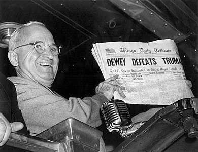 Harry S. Truman holds a copy of the Chicago Daily Tribune at "Dewey Defeats Truman", by Byron H. Rollins