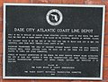 Historical marker on the station exterior.