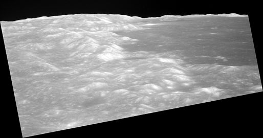 Low-altitude view of southern Mare Crisium from Apollo 11, facing northwest and showing the crater Shapley near center at the edge of the mare, and the distal wall of the crater Greaves near the horizon