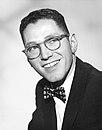 Tom Lehrer, retired musician and satirist. Lectured in American studies, Mathematics, and Musical Theater