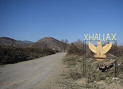 Entrance to the village, sign reading "Khnatsakh" in Cyrillic script