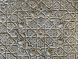Star-like polygonal geometric motif (with arabesque details) in stucco wall decoration at the Alhambra (14th century, Nasrid)