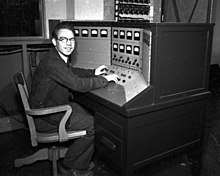 Photo of Backus at the control panel for the Berkeley Lab 60-inch cyclotron