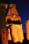 Ramesses II colossus inside Luxor Temple at night