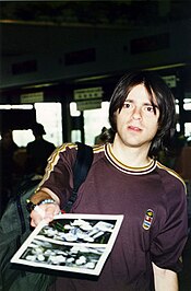 Weezer frontman Rivers Cuomo pictured in the 1990s, a young white man with long dark hair