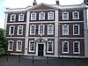 Photograph of the Georgian style hall in three storeys, showing three bays with three windows in the central bay and two windows in each of the lateral bays