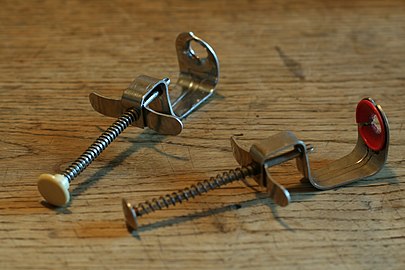 Cherry pitters with spring mechanism