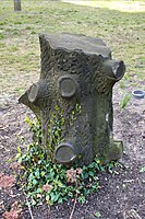Unconventional tombstone in the Cemetery Park of the "Freireligiöse Gemeinde" in Berlin, Prenzlauer Berg. Tree stump headstones in U.S. cemeteries are often associated with fraternal organization Woodmen of the World.