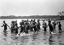 Orphan girls playing in the Tidal Basin in 1924. A float and a diving platform are in the background.