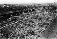 Black and white aerial photograph of a devastated urban area