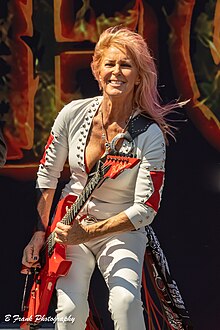 Lita Ford playing a guitar onstage