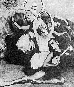 Black and white photo of five dancers posing in front of a forested backdrop