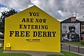 The Free Derry wall in 2018, painted yellow as part of a campaign to raise awareness about sarcoma.