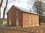 Front and side of the church; the side has three windows.