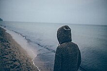 a guy (which isn't me) in a hoodie overlooking a shoreline