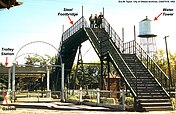 The footbridge allowed trolley passengers to safely cross the train tracks into the park; it was a major attraction for youngsters who ascended to view the approaching smoke-billowing trains (1952).