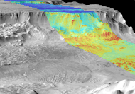 Combined infrared and daytime observation of Melas Chasma. The shadowed regions (blue) indicate successive landslides.