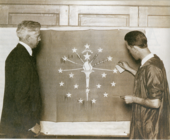 Paul Hadley, left, designer of the state flag with the flag that was presented to the state.