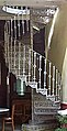 A cast iron spiral staircase showing the central newel post that supports the treads, risers and balustrade.