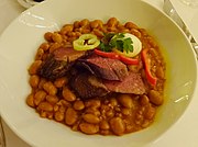 Cholent, a stew of beans topped with smoked goose