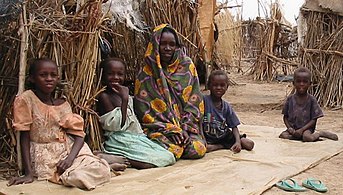 A Sudanese family sitting in a refugee camp