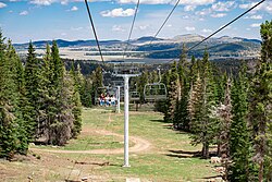 Scenic chairlift riders on the Sunrise High-Speed Quad in the summer