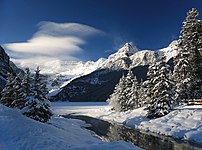 A winter cloud sweeps over the Victoria Glacier at Lake Louise, Canada.