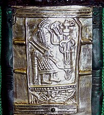 A wolf headed warrior on the Gutenstein scabbard [de].