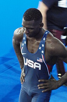 Vera looking downwards, in a blue uniform