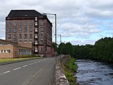 Former mill buildings by the River Teith, now Deanston Distillery