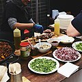 Fresh street food from around the world is prepared and sold on-site at the market.