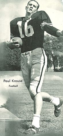 Paul Krause in a football jersey with no helmet carrying a football.