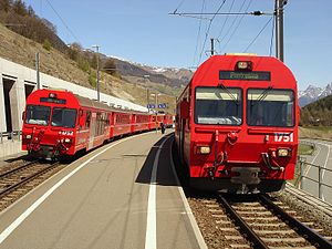 Red trains on each side of an island platform