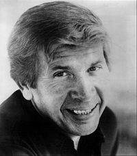 A black-and-white headshot of singer Buck Owens.