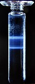 Caesium chloride (CsCl) solution and two morphological types of rotavirus. Following centrifugation at 100g a density gradient forms in the CsCl solution and the virus particles separate according to their densities. The tube is 10cm tall. The viruses are the two "milky" zones close together.