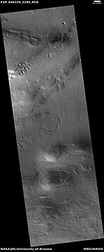 Wide view of slopes that contain tilted layered features, as seen by HiRISE under HiWish program