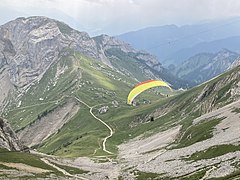 Paraglider taking off from summit