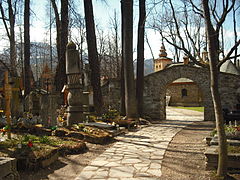 Old Cemetery in Pęksowy Brzyzek with the Church of Our Lady of Częstochowa in the background