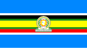 Nine horizontal strips coloured (from top to bottom): blue, white, black, green, yellow, green, red, white, then blue. The logo of the EAC is placed in the centre.