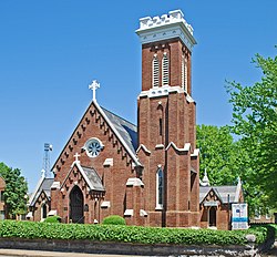 Brick church with tall three-story belltower