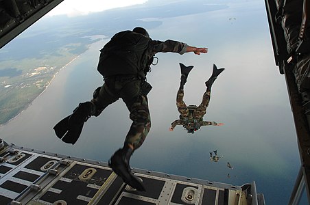 Airmen jumping out of an aircraft, by Julianne Showalter (edited by Sémhur)