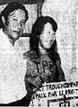 Mrs. Ngo Ba Thanh poses with her husband and the posters she made during two years of imprisonment, 1973