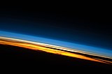 Limb view of Earth's atmosphere. Colors roughly denote the layers of the atmosphere.