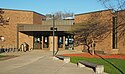 Golden Valley branch, a one-story brick building located in a grove of trees.