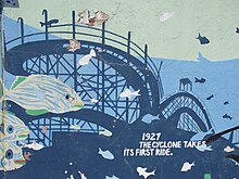 Wall of the New York Aquarium, with blue-painted fish and the Cyclone