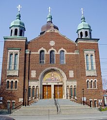 Exterior view of the main entrance of bricked Ukrainian Orthodox Cathedral with three spires with crosses atop them