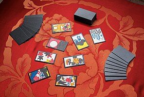 A typical setup of hanafuda for the game of Koi-Koi, on top a red zabuton with a peony pattern.
