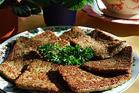 A pound of sliced, pan-fried livermush, garnished with parsley
